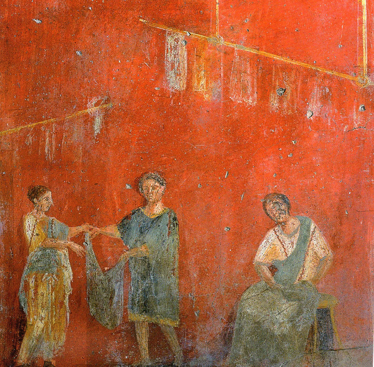 A Roman wall painting: three people handling a length of cloth, the man in the centre in a short blue-grey belted tunic, the woman at left in a long yellow one.